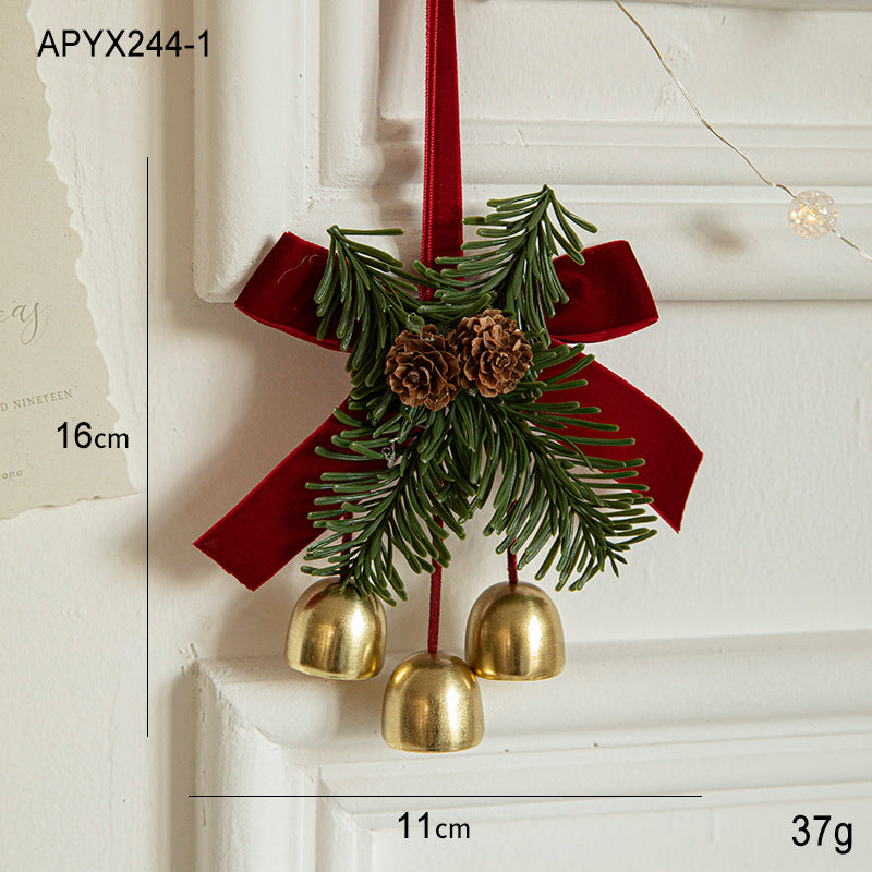 Christmas door hanging ornament with pinecones, evergreen sprigs, gold bells, red ribbon