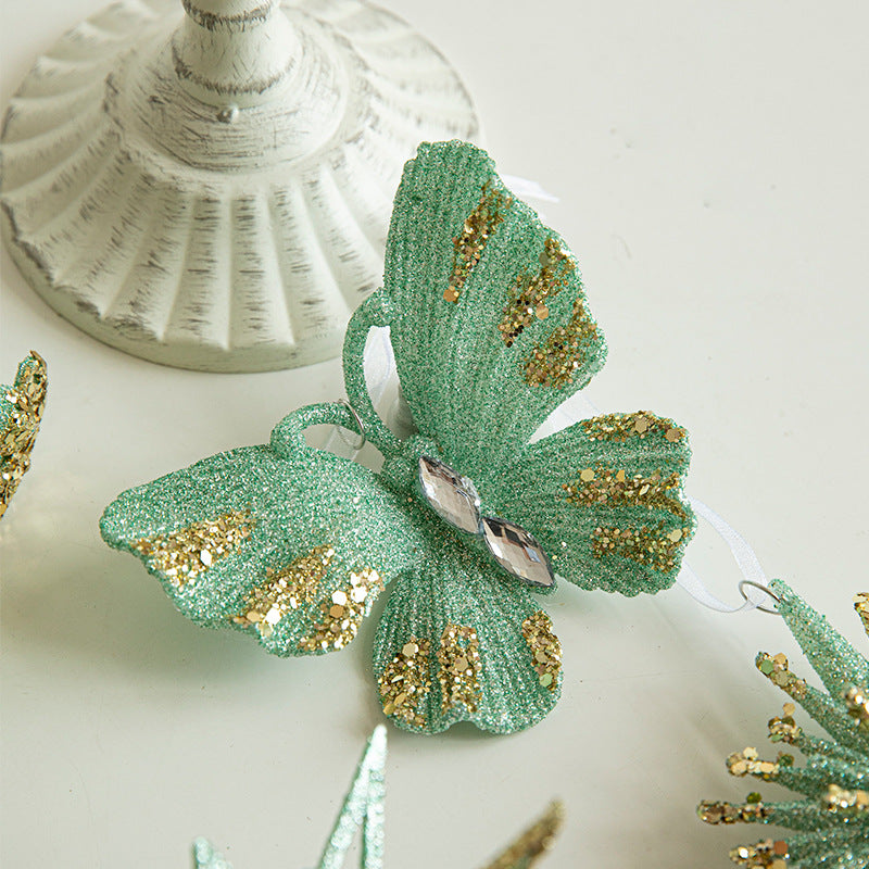 Hanging green glitter butterfly ornament with gold accents, faceted body and loop