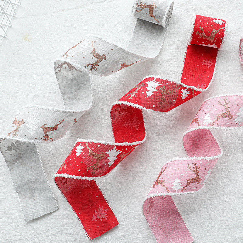 Christmas decorative wired ribbon pieces with reindeer and tree prints in red and pink