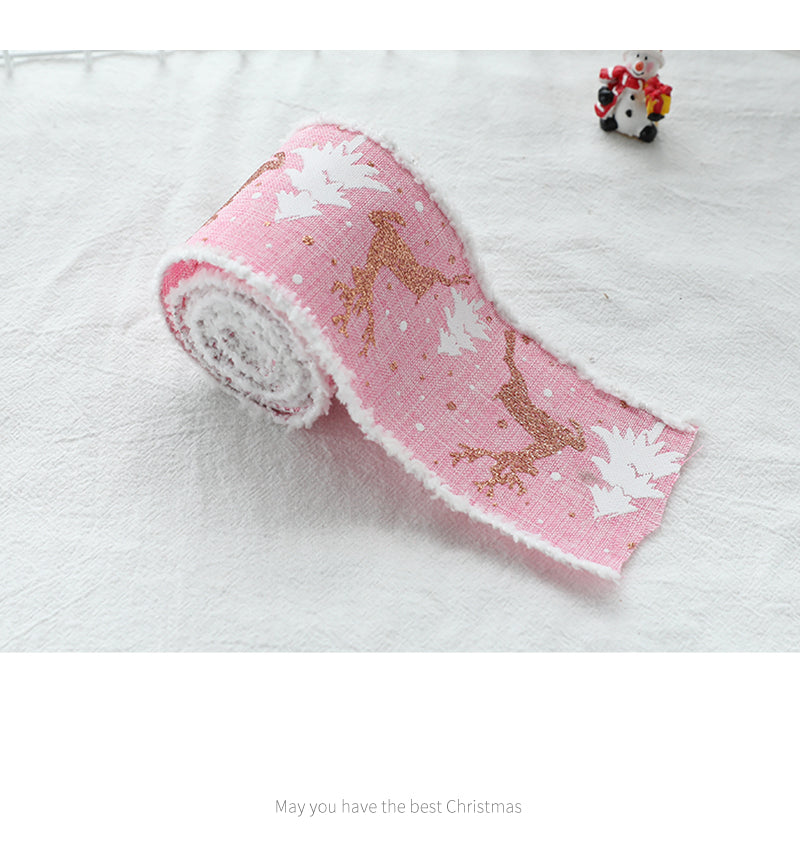 Christmas decorative wired ribbon roll in pink with gold reindeer and white tree motifs
