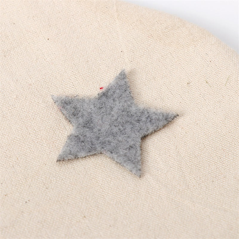 Blue felt star appliqué on beige gnome stocking
