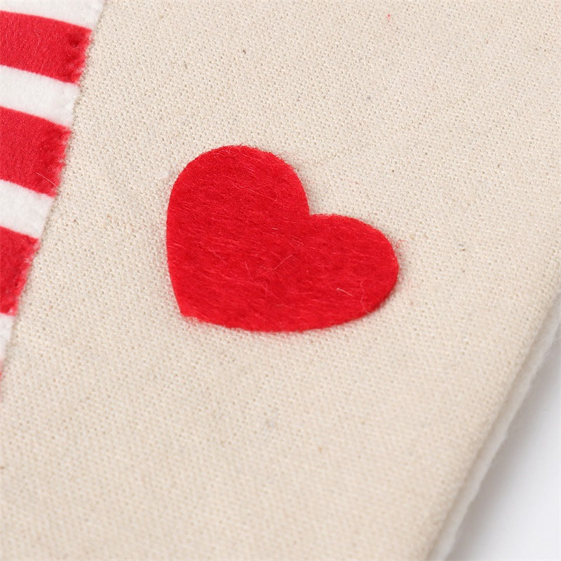 Red felt heart appliqué on beige gnome stocking