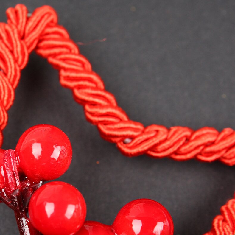 Red braided star border with glossy red bead bells and pine accents