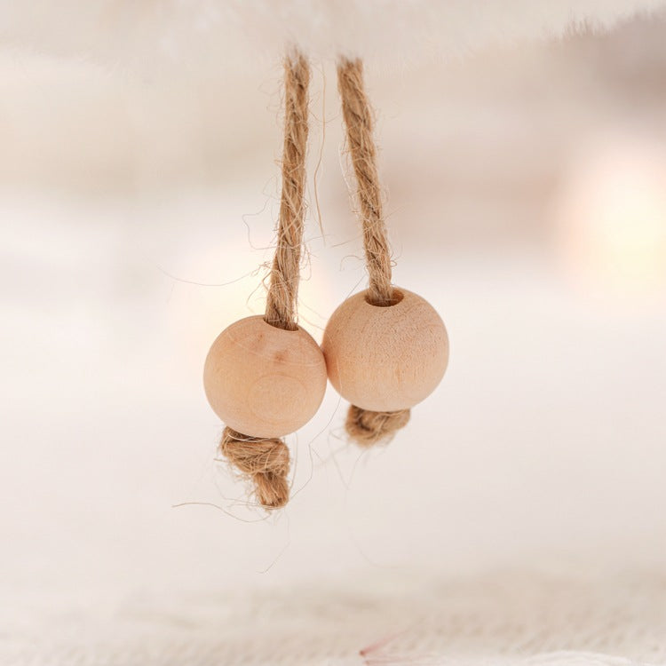 Hanging ornament with two wooden bead feet and twine string loop