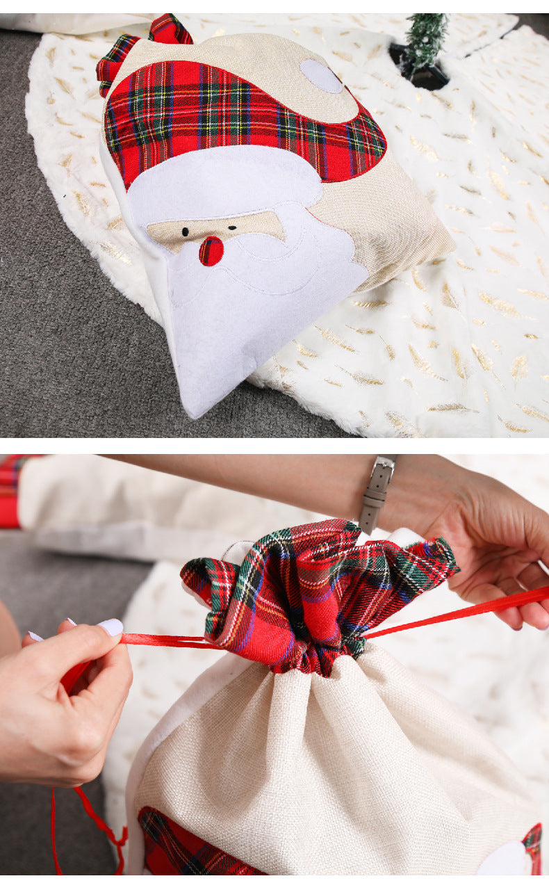 Santa Claus drawstring gift bag, hands pulling the cord with red plaid accents