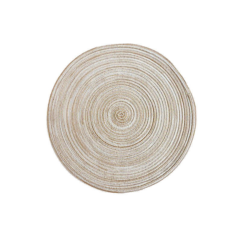 Round beige woven placemat with spiral-ridged circular weave pattern