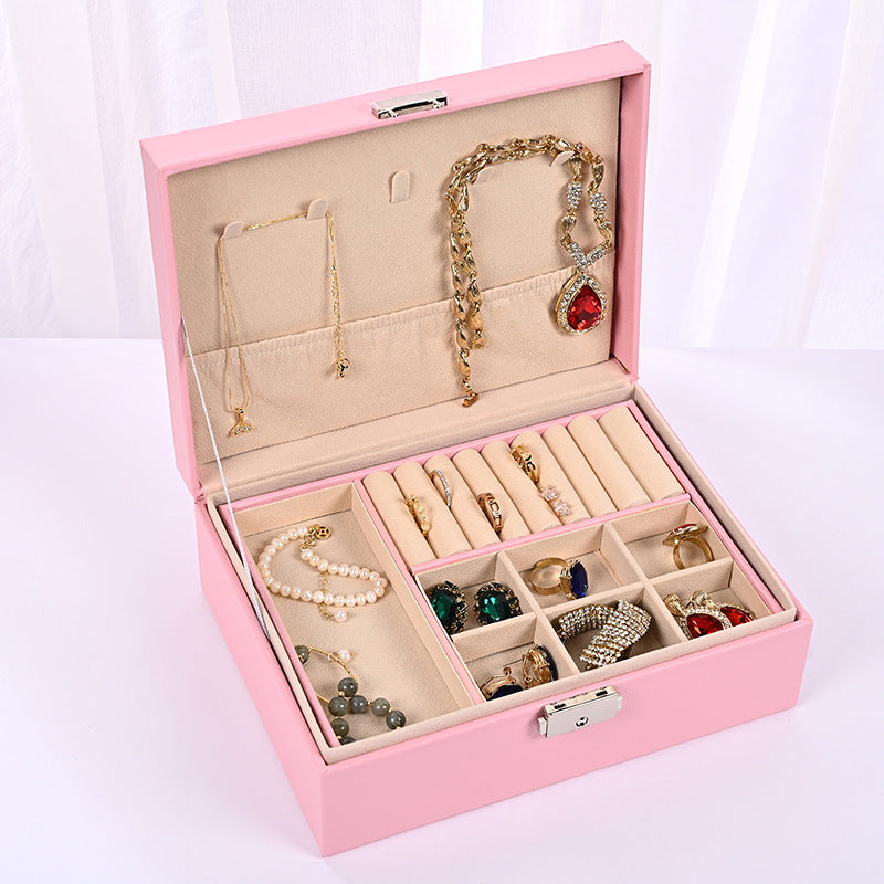 Pink jewelry organizer box with open lid showing necklace hooks and ring slots