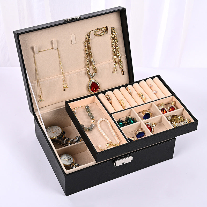 Black jewelry organizer box open with multi-compartment trays for rings and necklaces