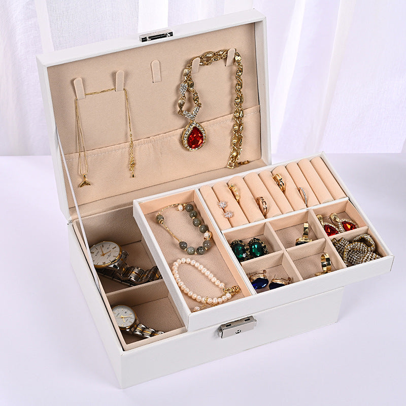White jewelry organizer box with open lid, multi-compartment tray for rings and necklaces