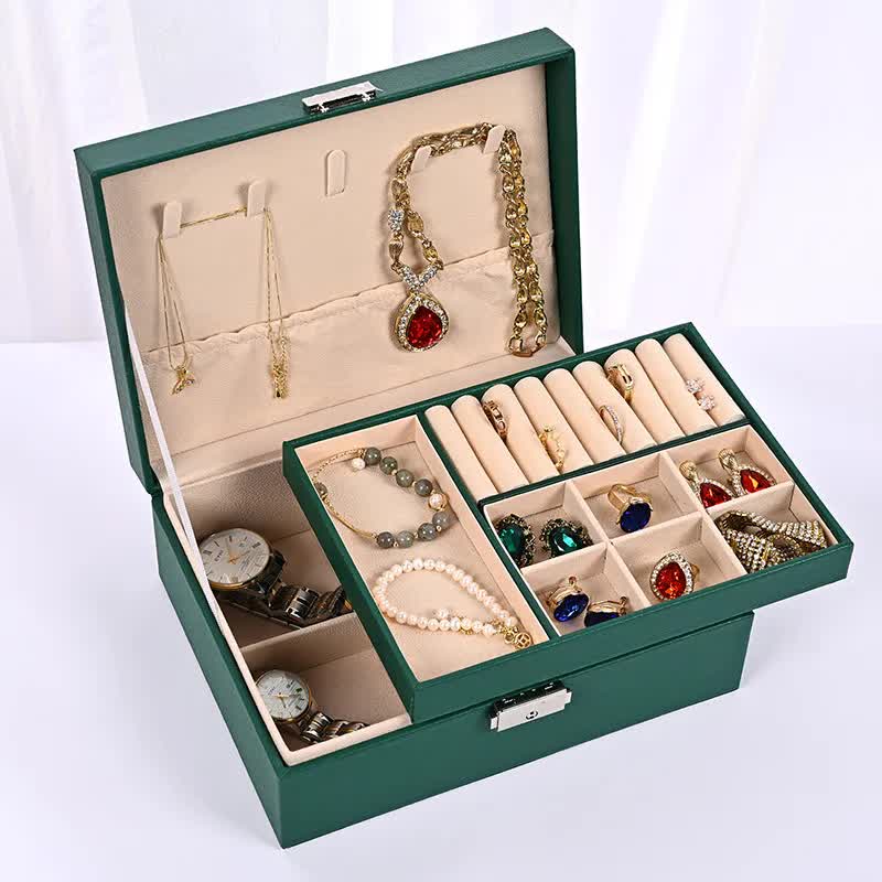 Green jewelry organizer box with open compartments for necklaces, rings, and bracelets