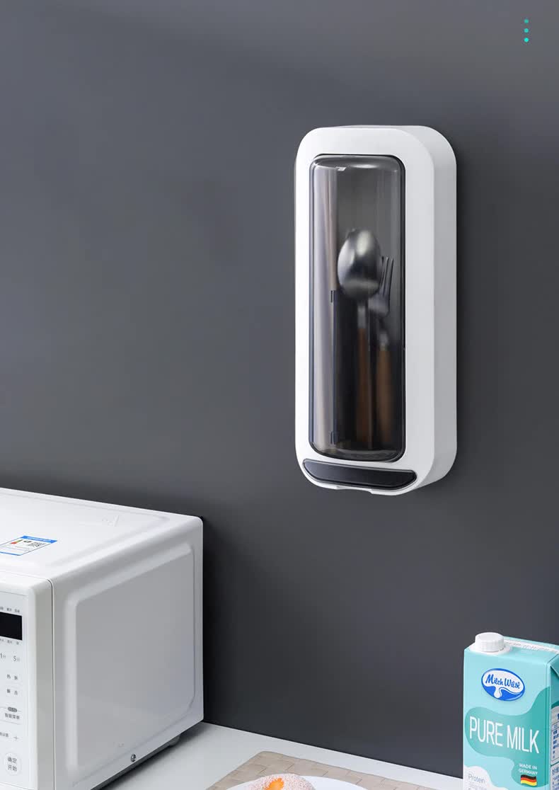Grey wall-mounted utensil holder with dustproof cover, holding metal cutlery inside