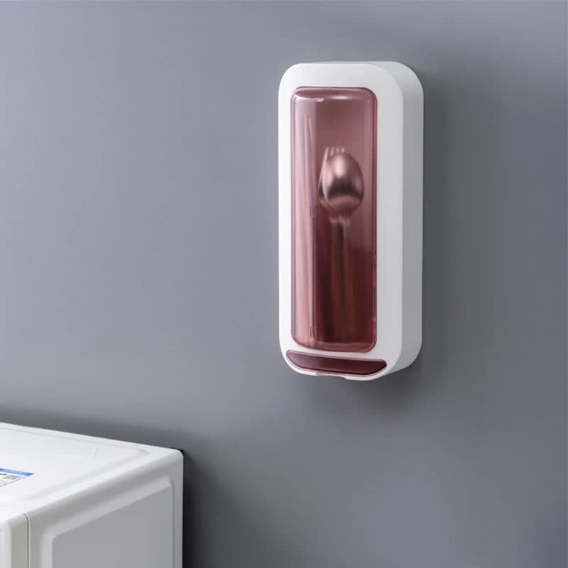 Wall-mounted utensil holder with dustproof pink cover on a wall, compact design.
