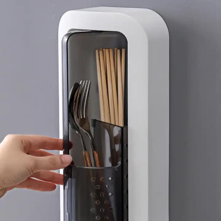 Wall-mounted utensil holder with dustproof cover open, holding metal and wooden utensils.