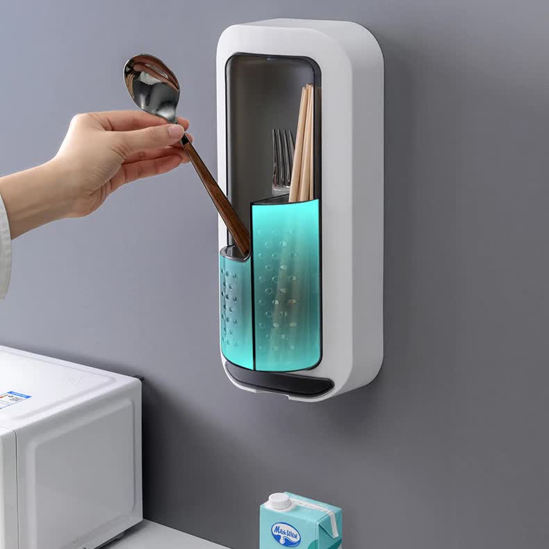 Wall-mounted utensil holder with cover, blue interior, utensils inside.