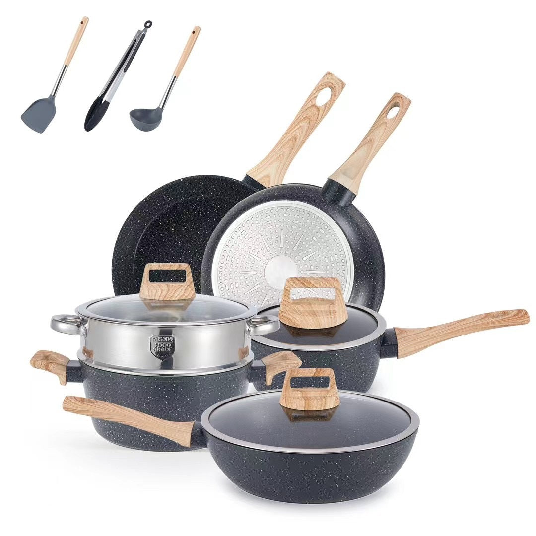 Speckled black nonstick pots and pans with wood-look handles, glass lid, and silicone spatulas