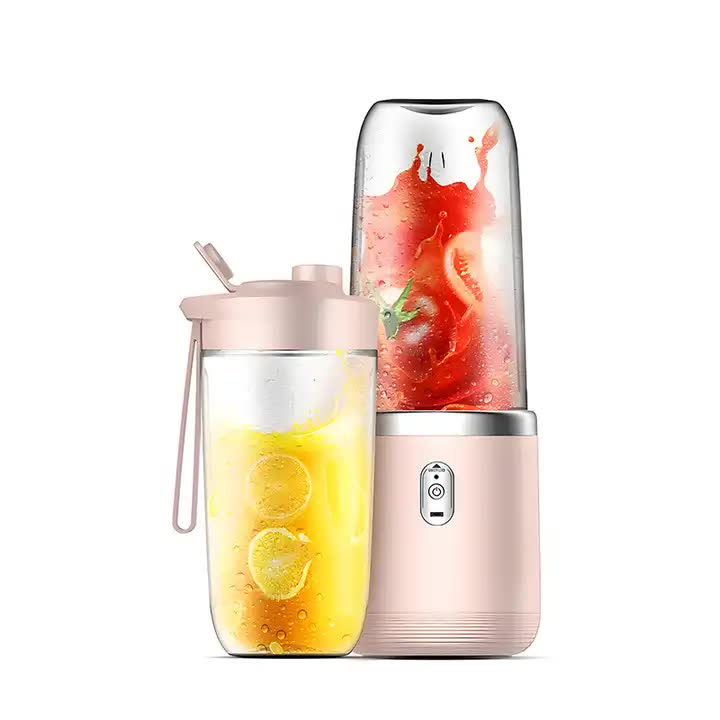 Pink portable blender base with two cups, one straw lid and blended fruit
