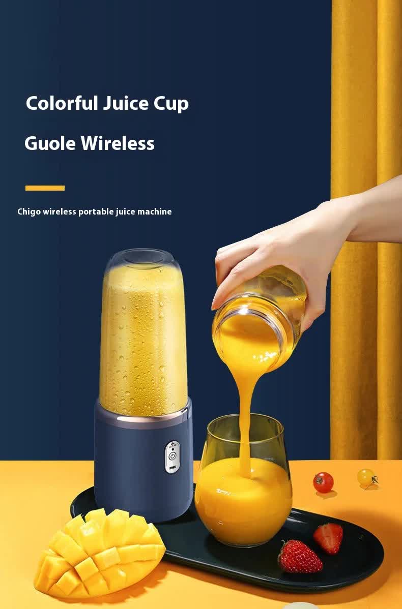 Blue portable blender with clear cup, pouring yellow juice into a glass cup