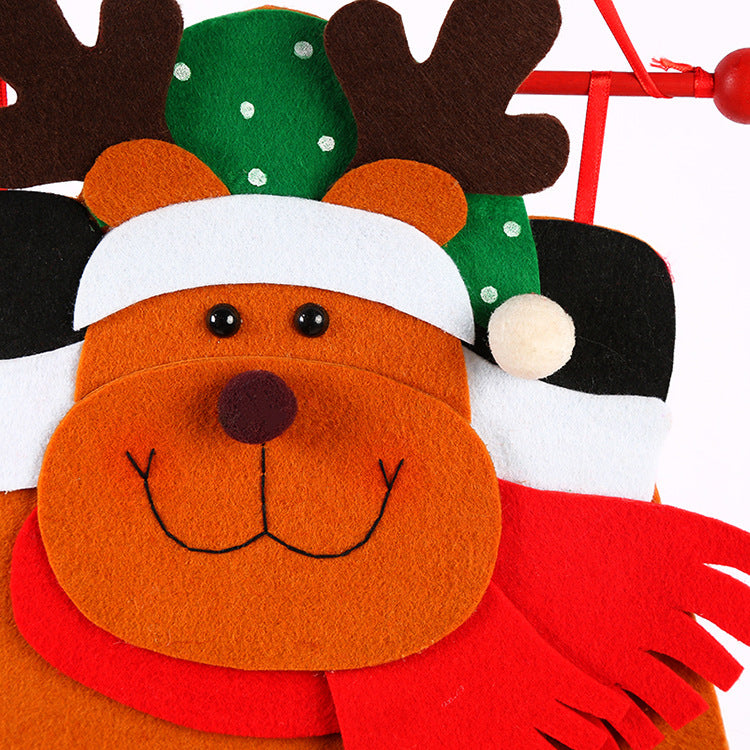 Felt reindeer advent calendar face with green hat and white muzzle with eyes