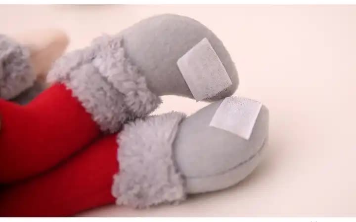 Plush Santa curtain tieback close-up of grey sleeve and red suit