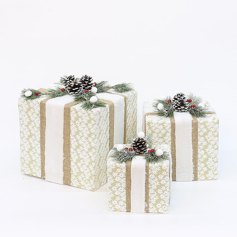 Set of 3 decorated gift boxes, white speckled with gold stripes and pinecone berry tops
