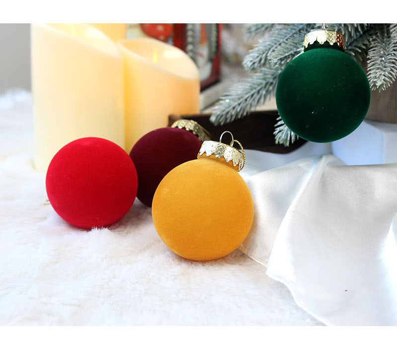 Velvet Christmas baubles in red, gold, and dark green with gold tops
