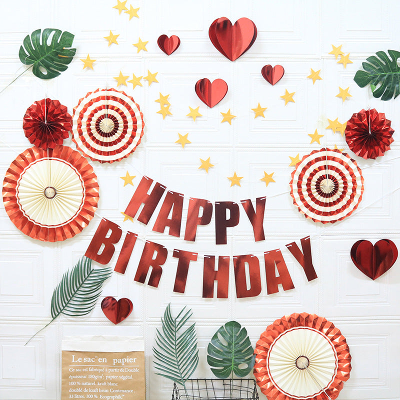 Birthday decoration set with Happy Birthday banner, red hearts, stars, and paper fans