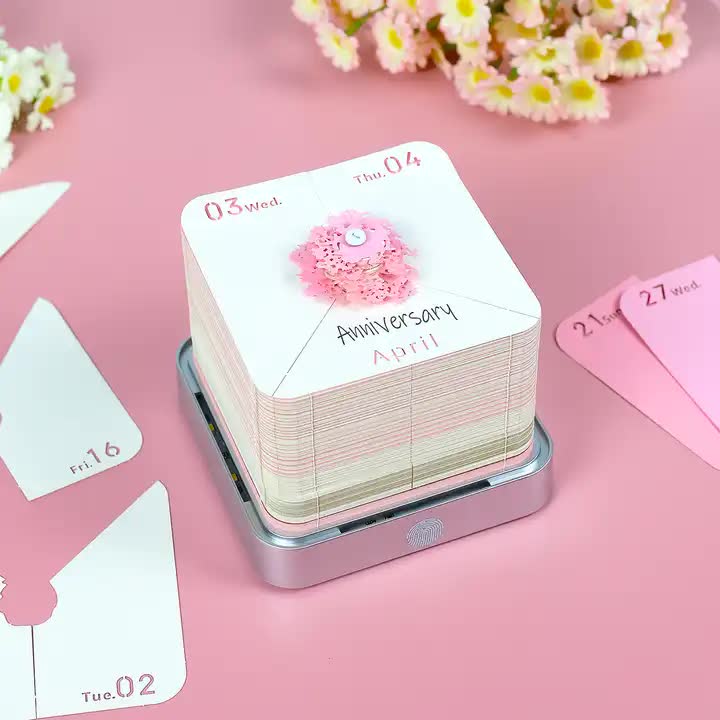 Pink notepad stack with date cards on black night light base