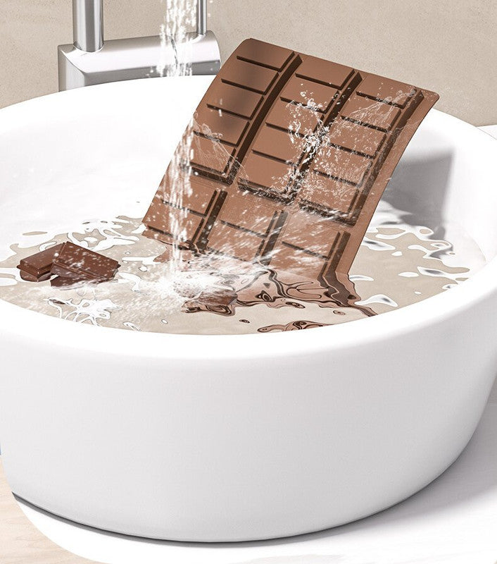 Brown silicone chocolate bar mold with cavity sections on a white bowl