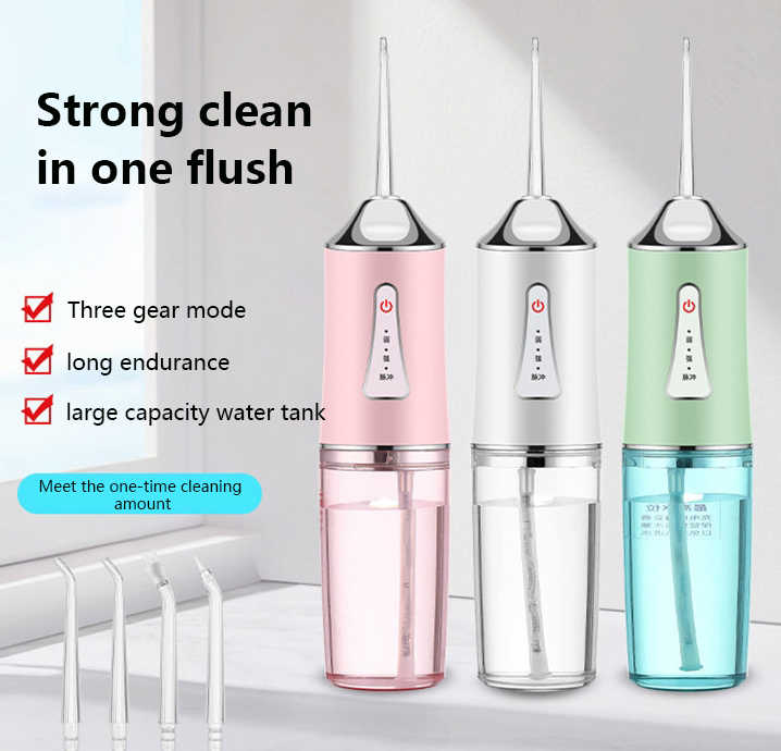 Set of portable water flossers in pink, white, and green with jet tips