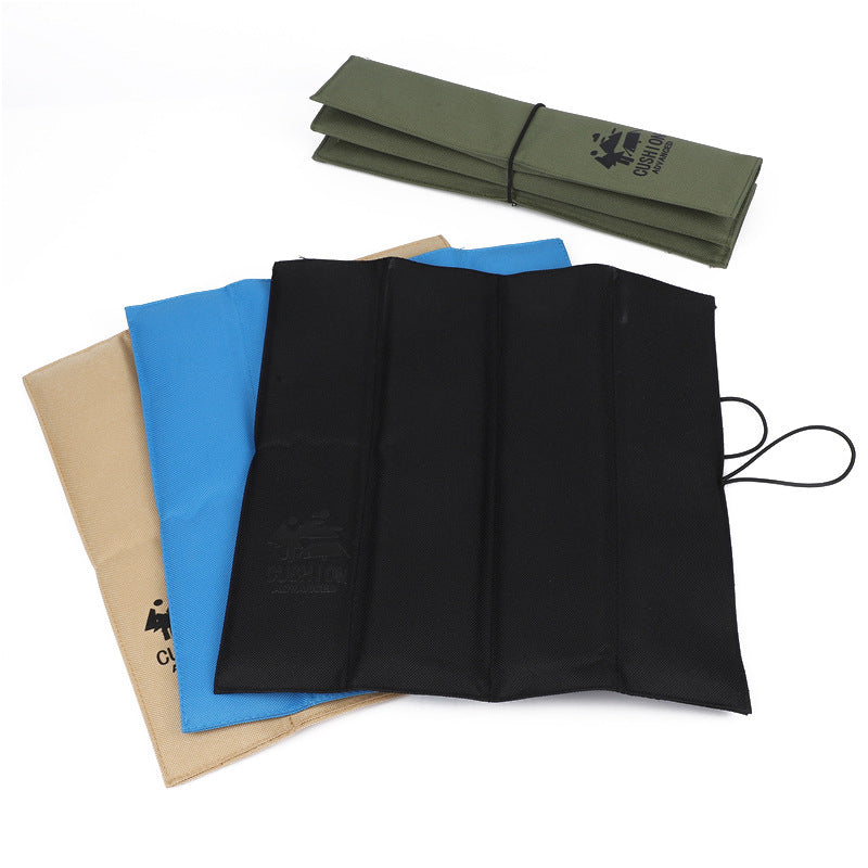 Set of foldable seat pads in green, black, blue and beige, with carrying cords
