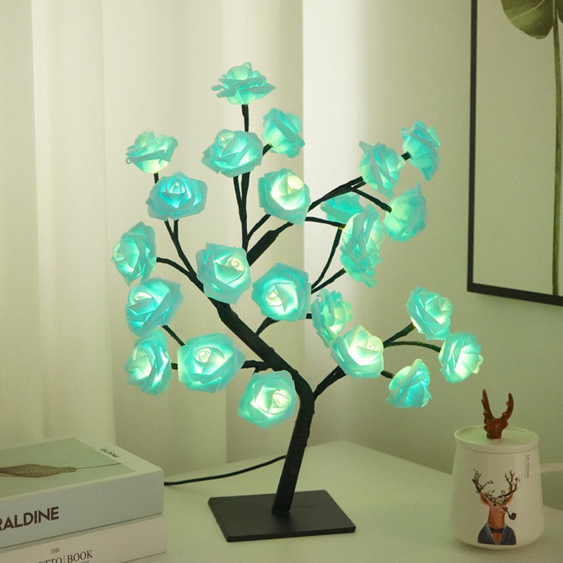 LED rose flower tree light with teal glowing rose blooms on a black base stand