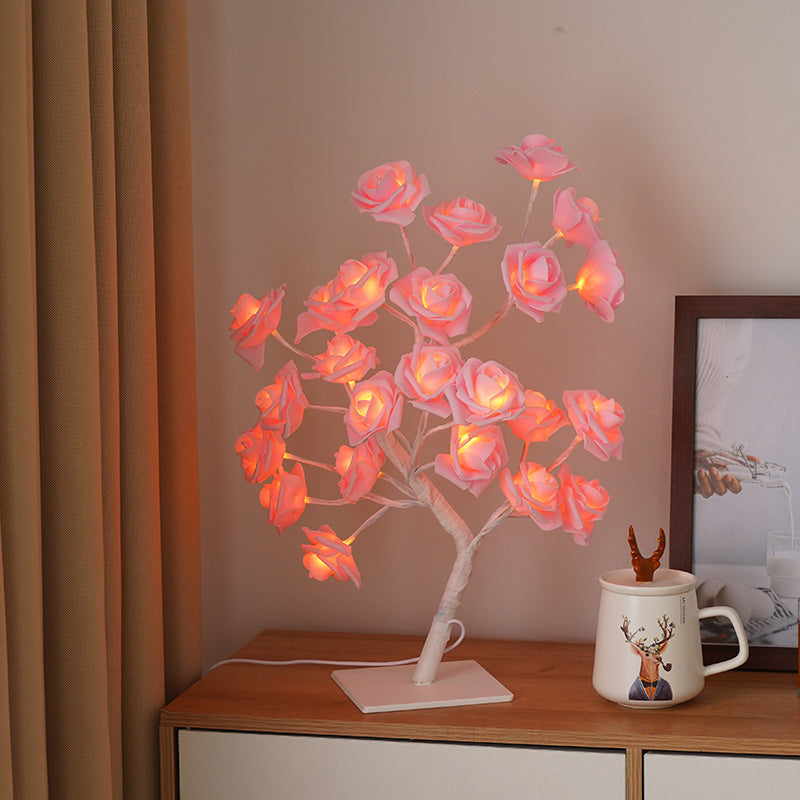 Rose flower tree night light with pink roses and warm orange LED glow on dark base
