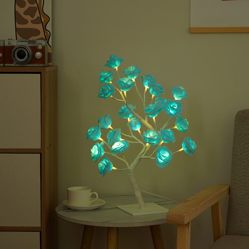 Rose flower tree light with turquoise glowing LEDs, dark branches on square base