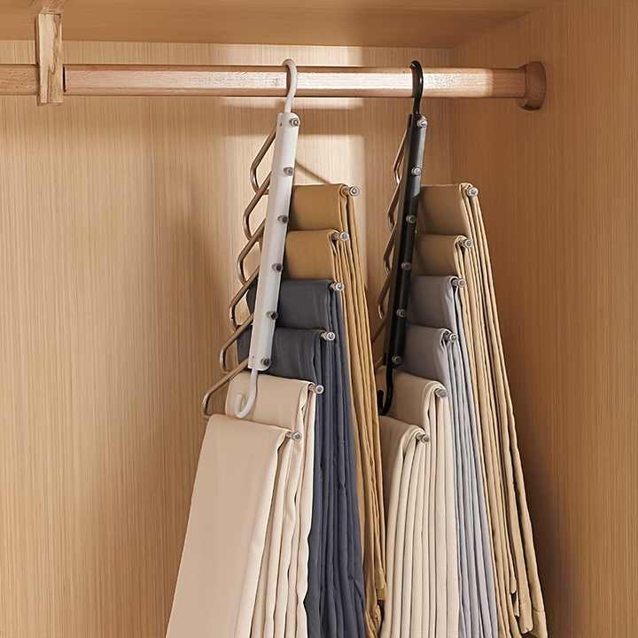 Foldable multi-layer pants hanger, white and dark frames with bar clips on a closet rod