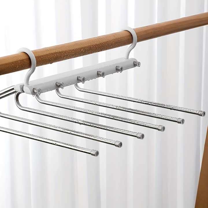 Multi-layer pants hanger close-up with several horizontal metal bars attached to a rod