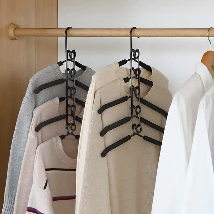 Multi-layer foam clothing hanger rack with five black non-slip arms and clips