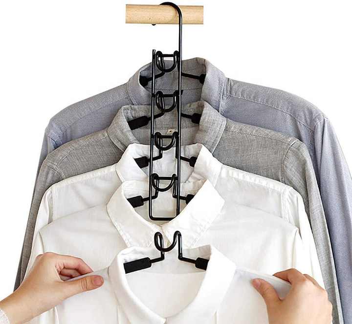 Black multi-tier foam hangers with detachable hooks, holding clothes