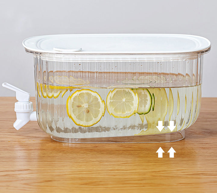 Clear cold drink dispenser tank with lemon slices, white spigot and water level