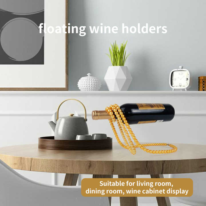 Gold pearl rope wine bottle holder suspending over a wine bottle on a table