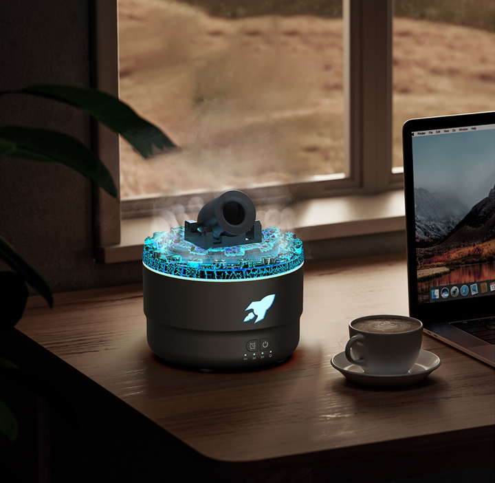 Black diffuser with teal glowing LED top ring and mist nozzle on a desktop