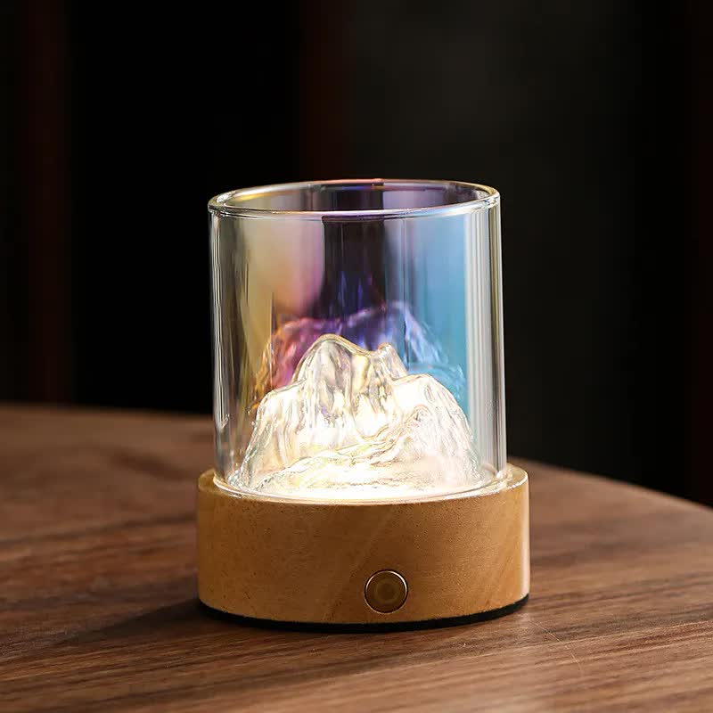 Glass mountain night light with illuminated mountain inside, clear cylinder, wooden base
