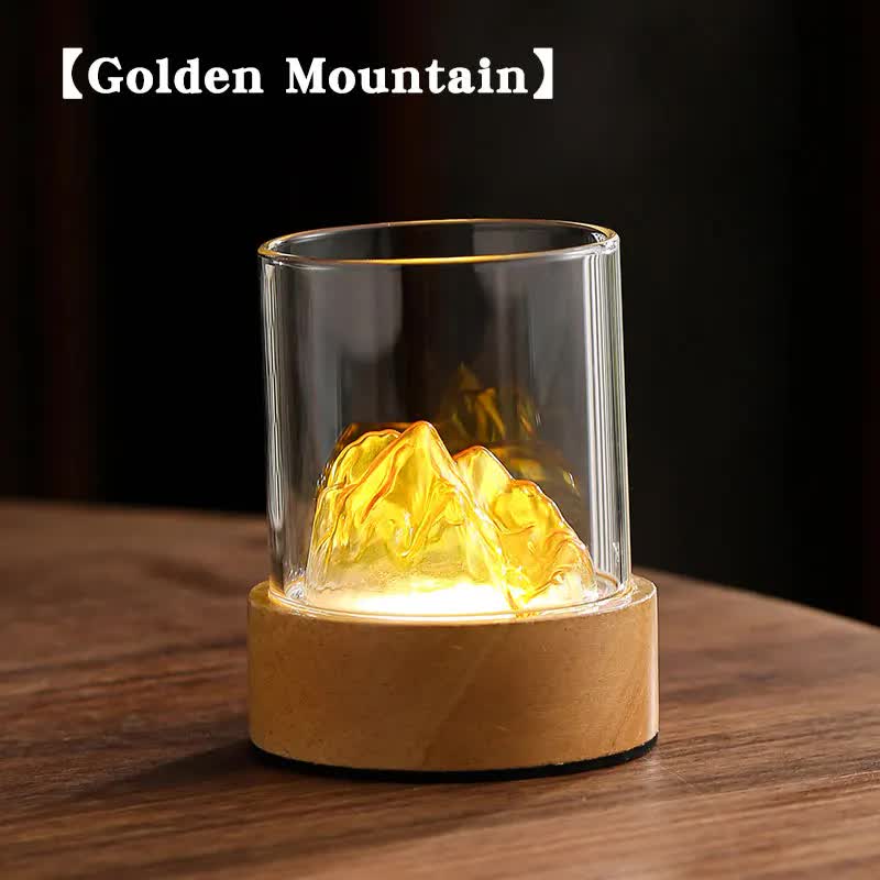 Glass mountain night light with clear cylinder, wooden base, warm glow
