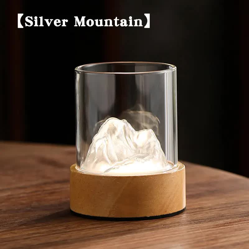 Mountain night light with clear glass cylinder and glowing white interior