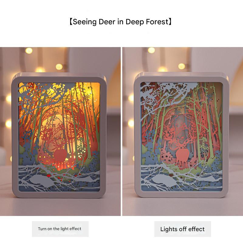 3D paper carving night light with deer-in-forest scene, illuminated through cutouts