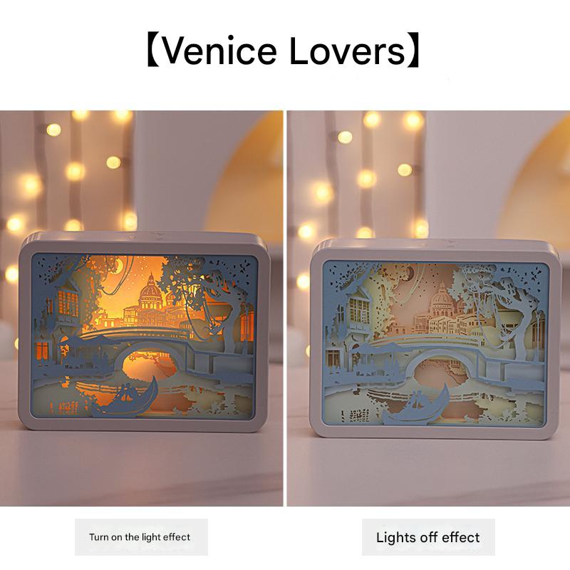 3D paper carving night light with orange city scene, blue-framed and lit