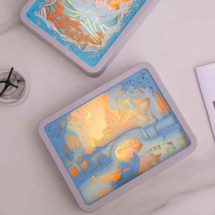 3D paper night light with blue frame, illuminated map and city scene