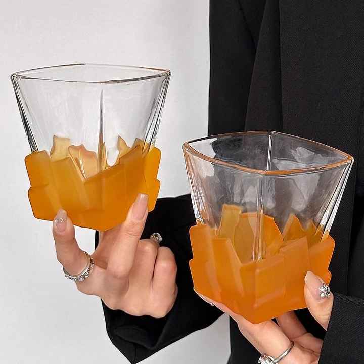 Orange frosted ice-cube tumbler glass with faceted block texture