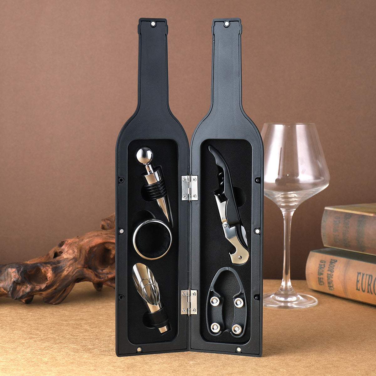 Wine tool set with corkscrew and pourer in black open case, plus wine bottle