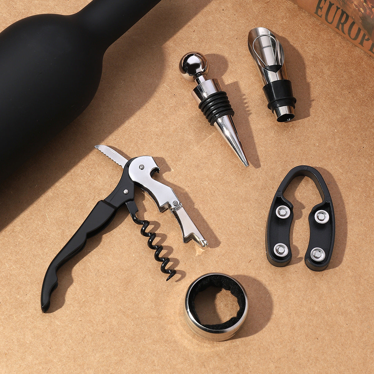 Wine accessories set with corkscrew, bottle opener, metal pour spouts, and cork pull ring