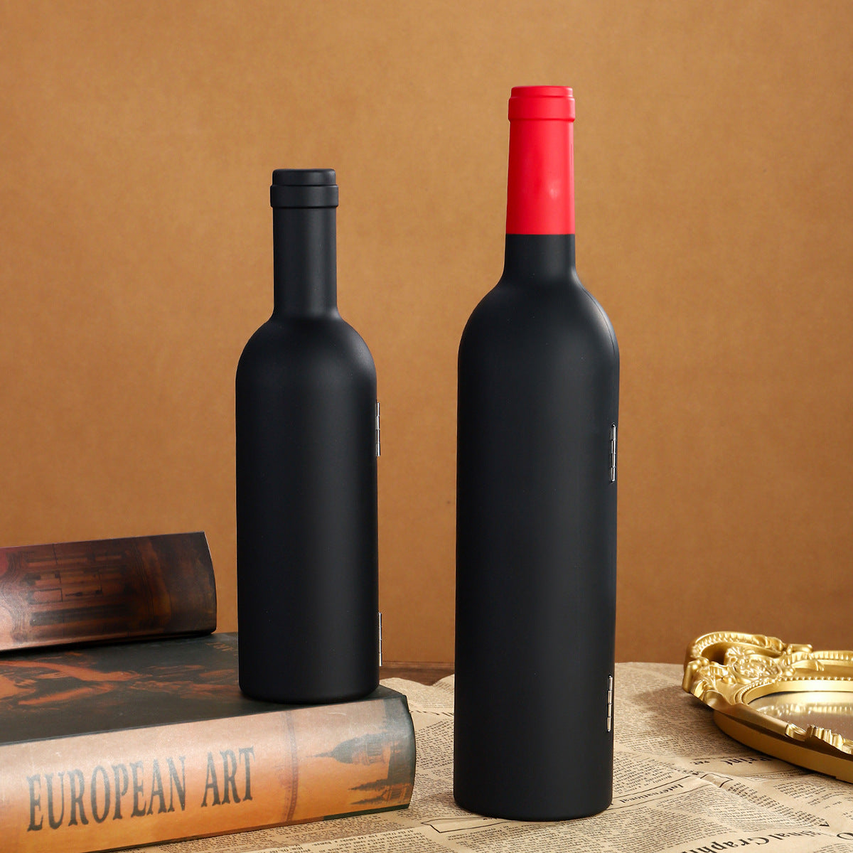 Wine accessory bottle pair with matte black bodies and red tops